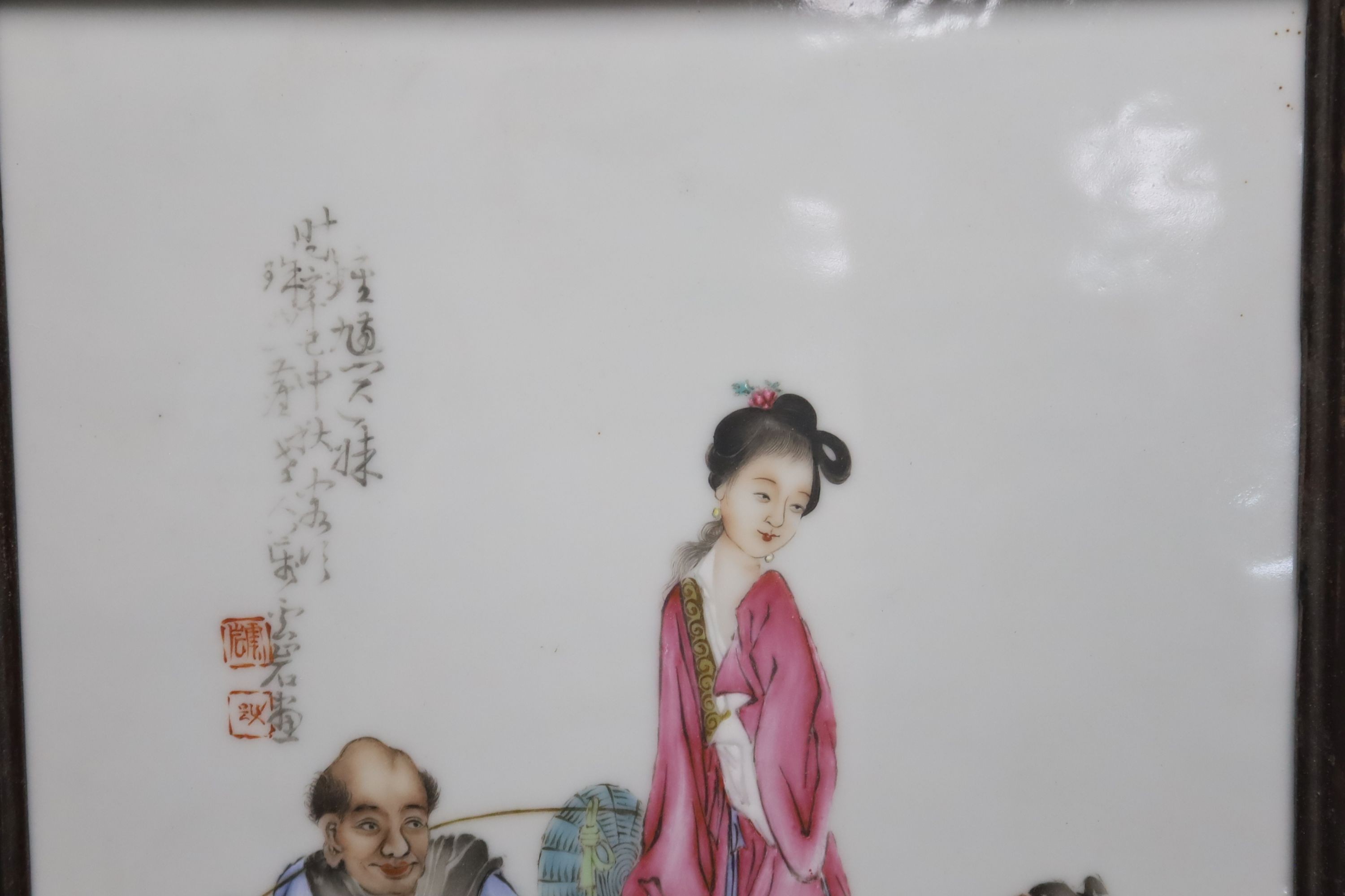 A Chinese framed poreclain plaque, painted with figures and script, height 44cm incl. frame